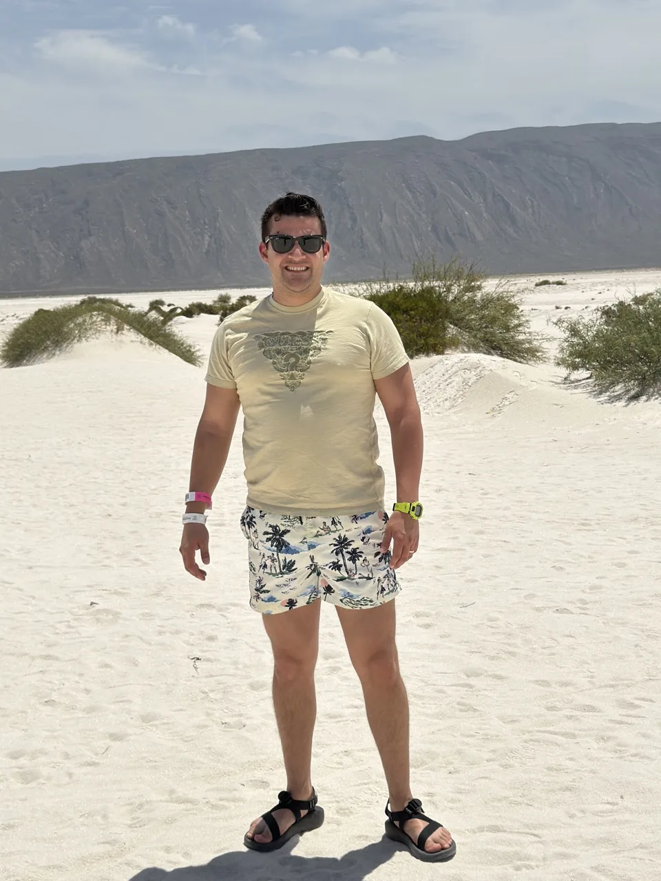 Eduardo Roth standing on white gypsum dunes in front of a desert mountain range